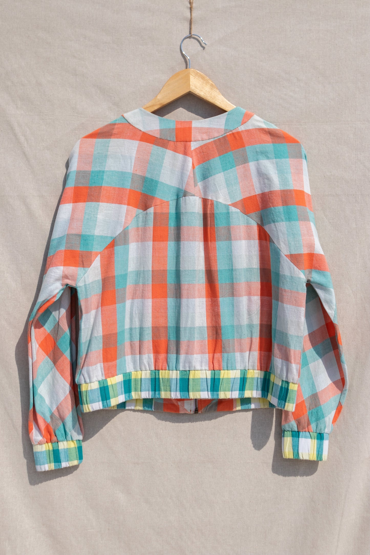 Multicolor Bomber jacket at Kamakhyaa by Anushé Pirani. This item is Checks, Easter, Handwoven Cotton, Jackets, July Sale, July Sale 2023, Multicolor, Natural, Of Myriad Minds, Office Wear, Playful Office Wear, Relaxed Fit, sale anushe pirani, Womenswear