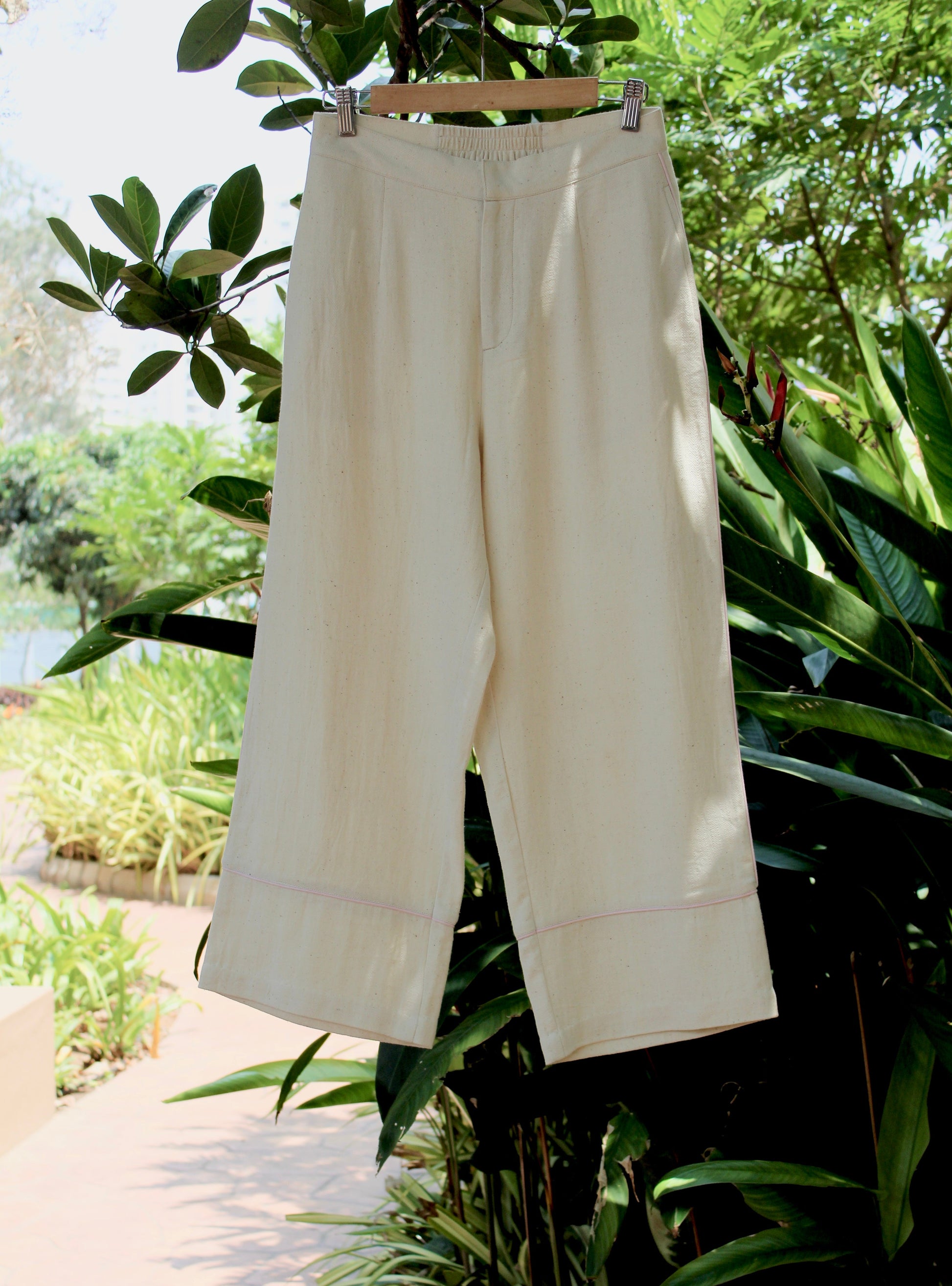 Off-white Pants at Kamakhyaa by Itya. This item is Hand Spun Cotton, Handwoven cotton, Natural, Off-white, Office Wear, Pants, Pastel Perfect, Pastel Perfect by Itya, Plant Dye, Relaxed Fit, Solids, SS22, Womenswear