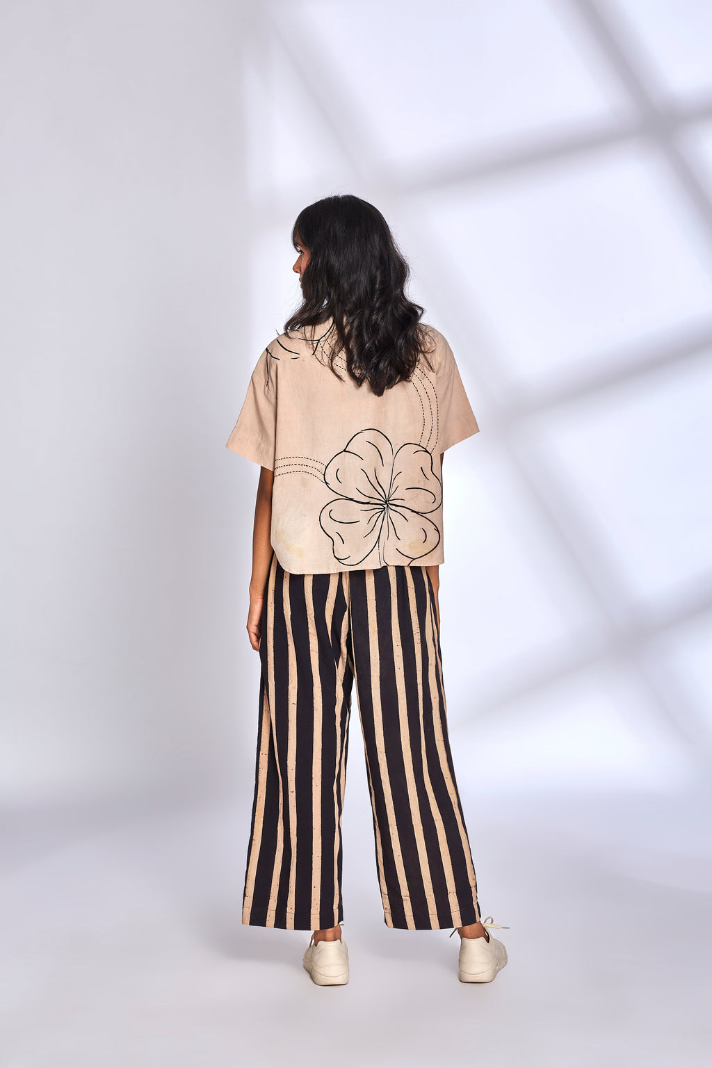 Beige Co-ord Set with Striped Pants at Kamakhyaa by Hasttvam. This item is Cotton, Floral, Fusion Wear, Handmade by Artisans, Natural dyes, Relaxed Fit, Respondible production and Vegan, White