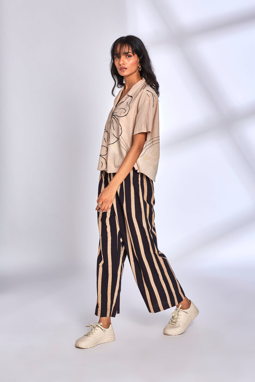 Beige Co-ord Set with Striped Pants at Kamakhyaa by Hasttvam. This item is Cotton, Floral, Fusion Wear, Handmade by Artisans, Natural dyes, Relaxed Fit, Respondible production and Vegan, White