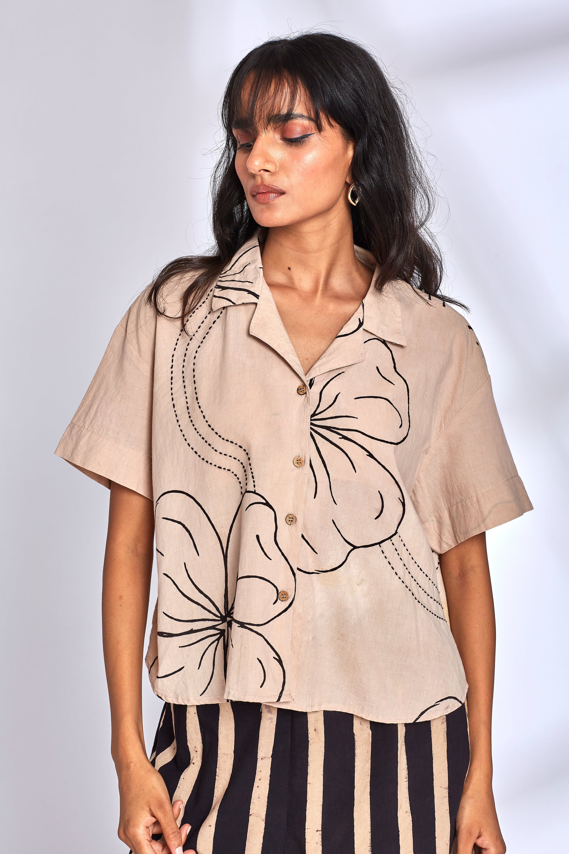 Beige Shirt for Women at Kamakhyaa by Hasttvam. This item is CottonFloralFusionWhiteHandmade by artisans, Floral, Natural dyes, Relaxed Fit, Respondible production and Vegan