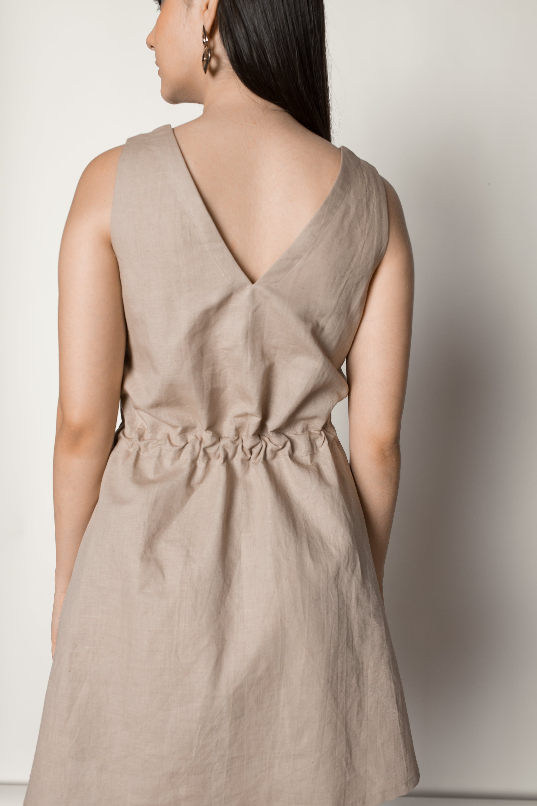 Beige Sundress with Drawstring at kamakhyaa.com by Anushé Pirani. This item is Beige, Birthday Collection, Casual Wear, Console Collection List, Cotton, Dresses, Hemp, Mini Dresses, Nostalgic Whispers by Anushe Pirani, Office Formals, Regular Fit, Review September 2025, Sleeveless Dresses, Solids, Womenswear