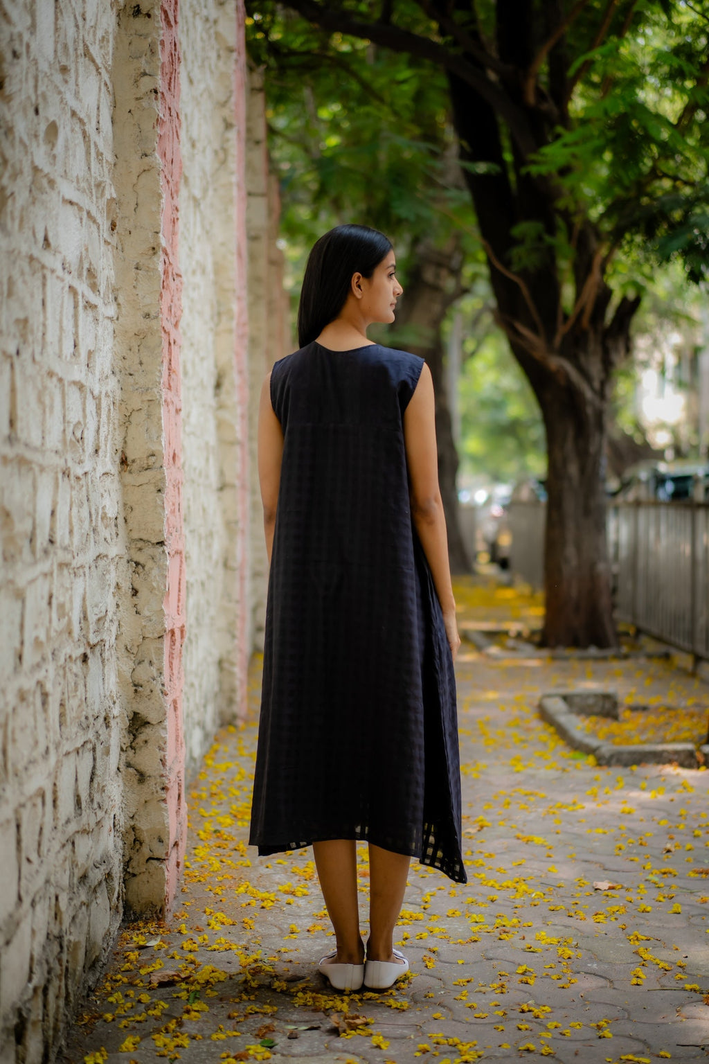 Black A-line Dress with Floral Hand-Embroidery at Kamakhyaa by Krushnachuda. This item is Black, Chilika by Krushnachuda, Embroidered, Handloom Cotton, Loose Fit, Natural Dye, Organic, Outerwear, Under $200, Womenswear