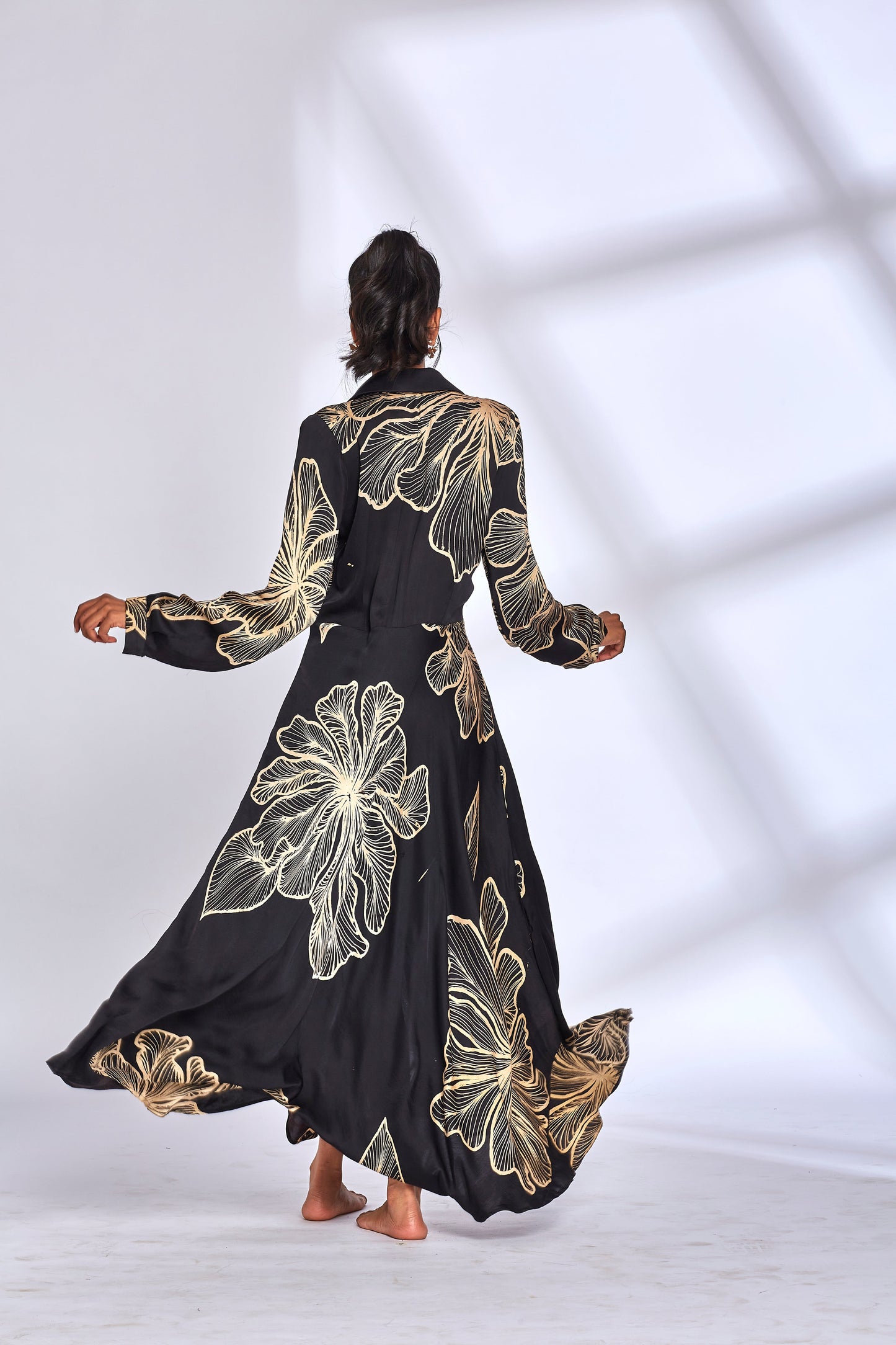 Black Printed Long Shirt Dress at Kamakhyaa by Hasttvam. This item is Black, Floral, Fusion Wear, Handmade by Artisans, Modal silk, Natural dyes, Printed, Respondible production and Vegan