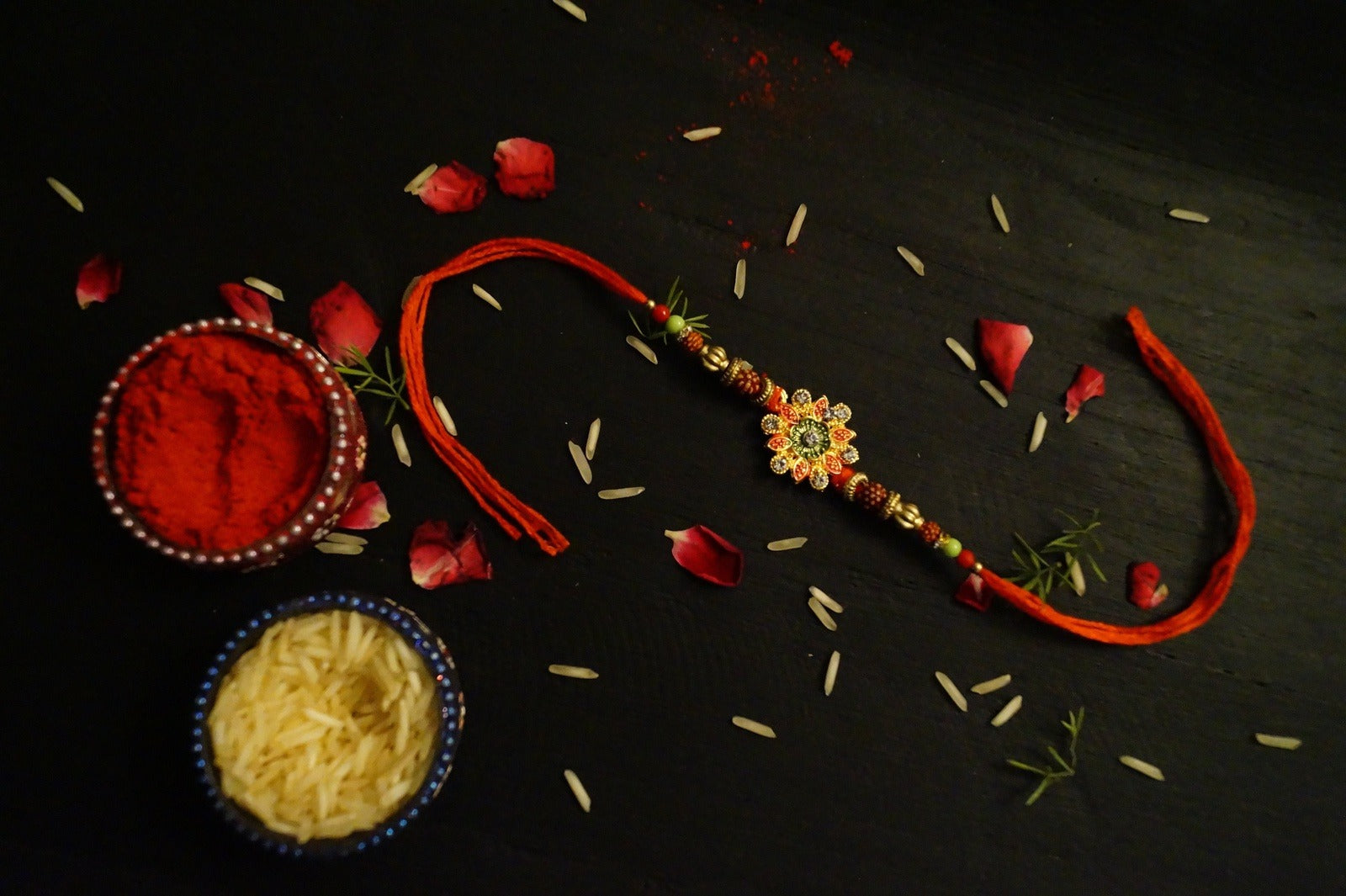 Floral Rudraksh Thread Rakhi at Kamakhyaa by Kamakhyaa. This item is jewelry, Natural, Rakhi, Red, Under 1500, Under 1750, Upcycled