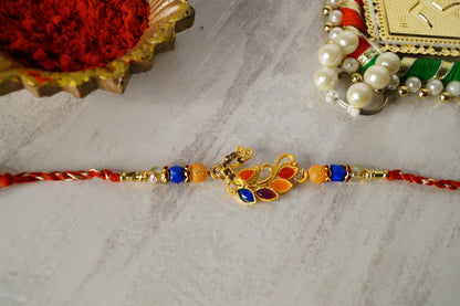 Peaccock Colorful Stone and Gold Brass Thread Rakhi at Kamakhyaa by Kamakhyaa. This item is Multicolor, Natural, Rakhi, Under 1500, Under 1750, Upcycled