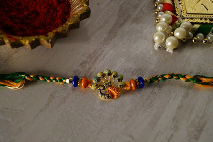 Peacock Stone Thread Rakshi at Kamakhyaa by Kamakhyaa. This item is jewelry, Multicolor, Natural, Rakhi, Under 1500, Under 1750, Upcycled