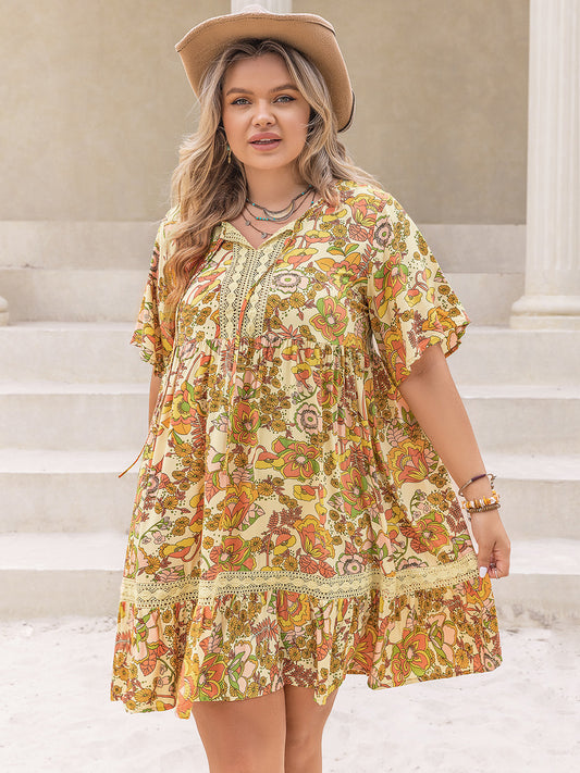 Plus Size Printed Tie Neck Short Sleeve Mini Dress at Kamakhyaa by Trendsi. This item is H.R.Z, Ship From Overseas, Trendsi