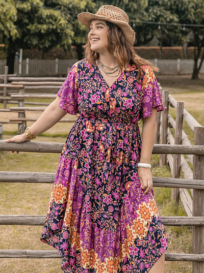 Plus Size Printed V-Neck Flutter Sleeve Midi Dress at Kamakhyaa by Trendsi. This item is H.R.Z, Ship From Overseas, Trendsi