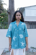 Seashell Camp Collar Shirt at Kamakhyaa by anushé pirani. This item is Blue, Cotton, Green, Moana, Recycled Cotton, Relaxed Fit, Resort Wear, Shibori Dyes, Tops, Under $150, Womenswear