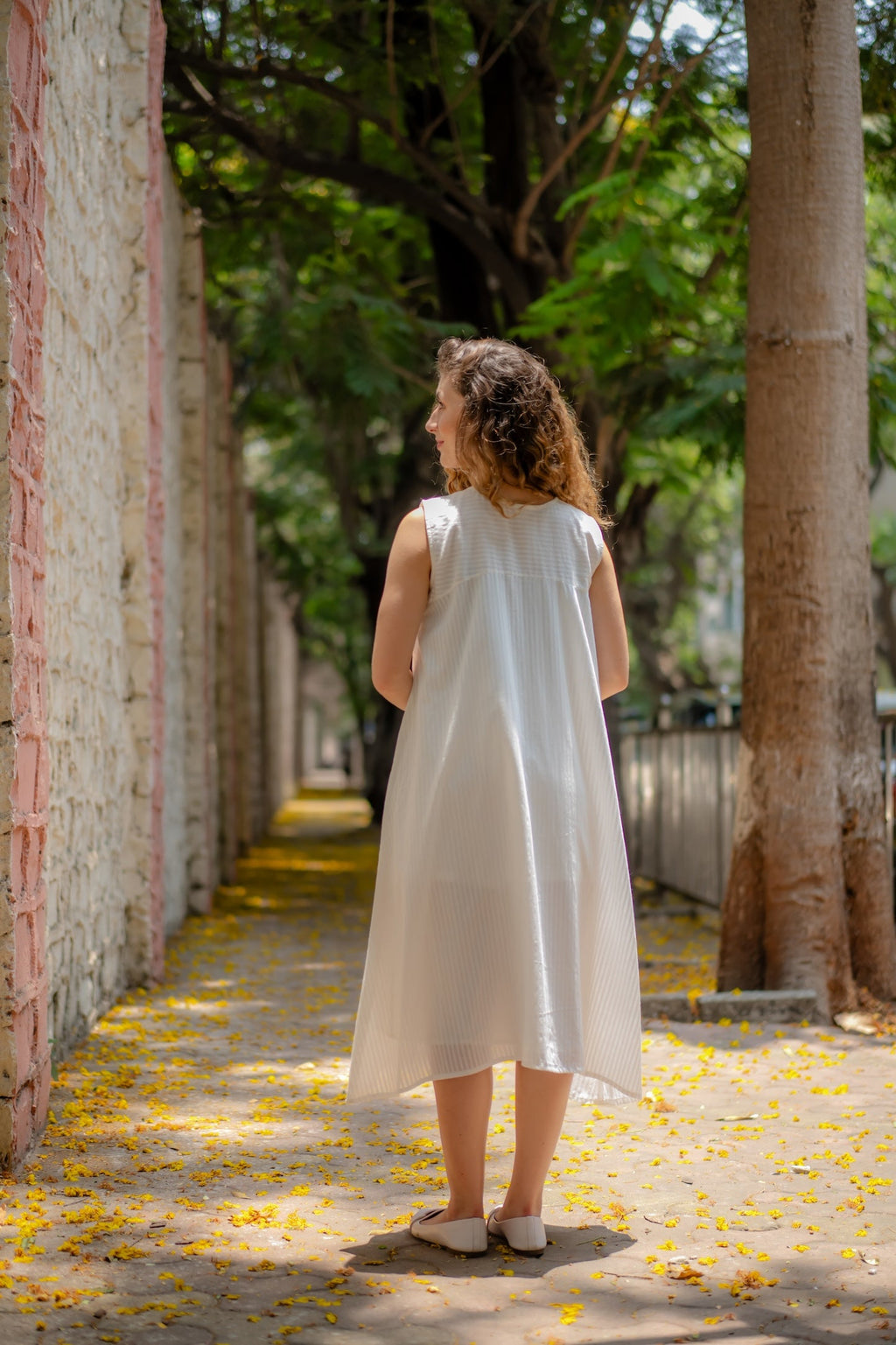 White A-line Dress with Floral Hand-Embroidery at Kamakhyaa by Krushnachuda. This item is Chilika by Krushnachuda, Embroidered, Handloom Cotton, Loose Fit, Natural Dye, Organic, Outerwear, Under $200, White, Womenswear