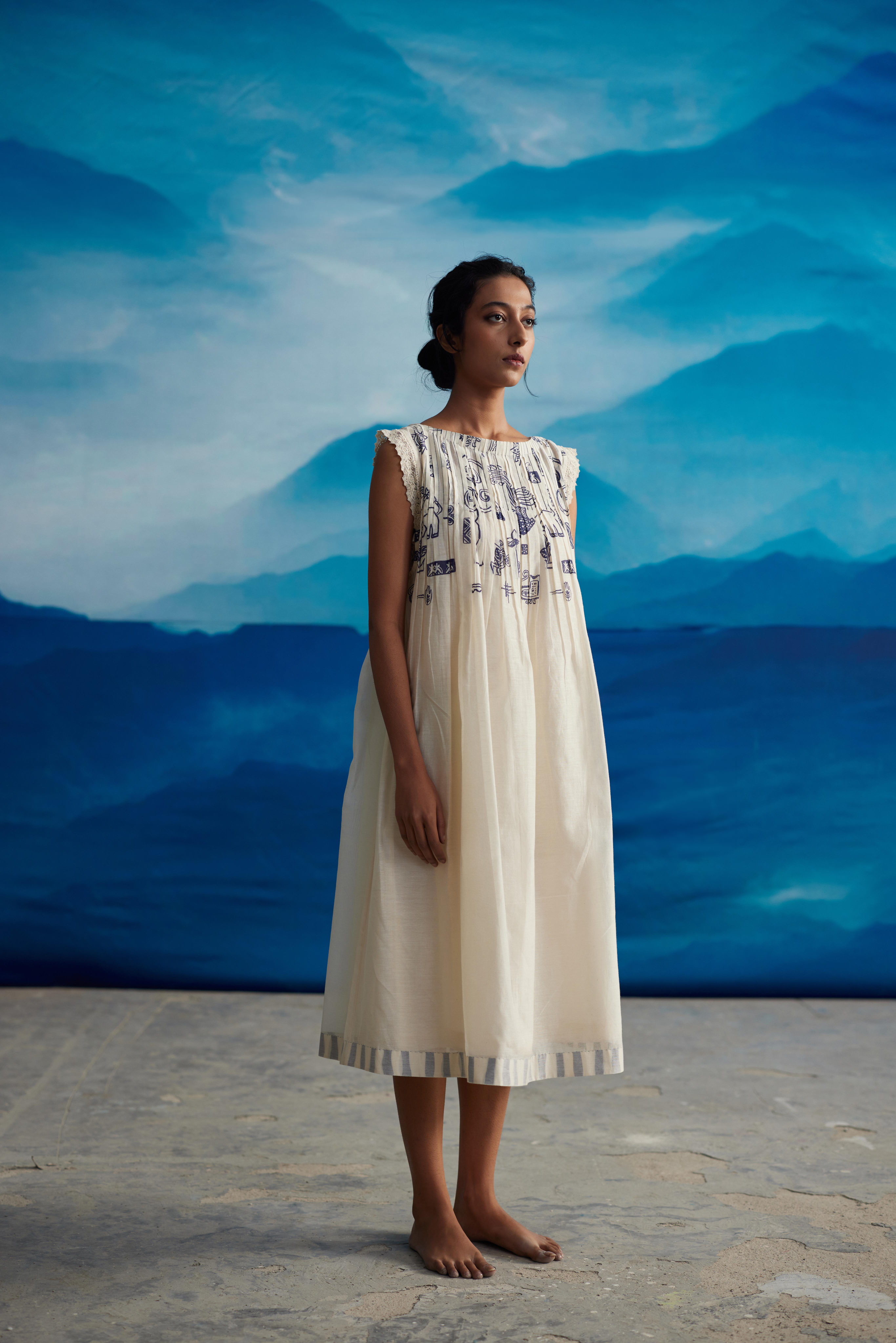 White Chanderi Pleated Midi Dress With Bow Tie-Up at Kamakhyaa by Ahmev. This item is Casual Wear, Chanderi, Indigo Eden by Ahmev, Korean Chic, Lace, Midi Dresses, Natural, Prints, Regular Fit, White, Womenswear