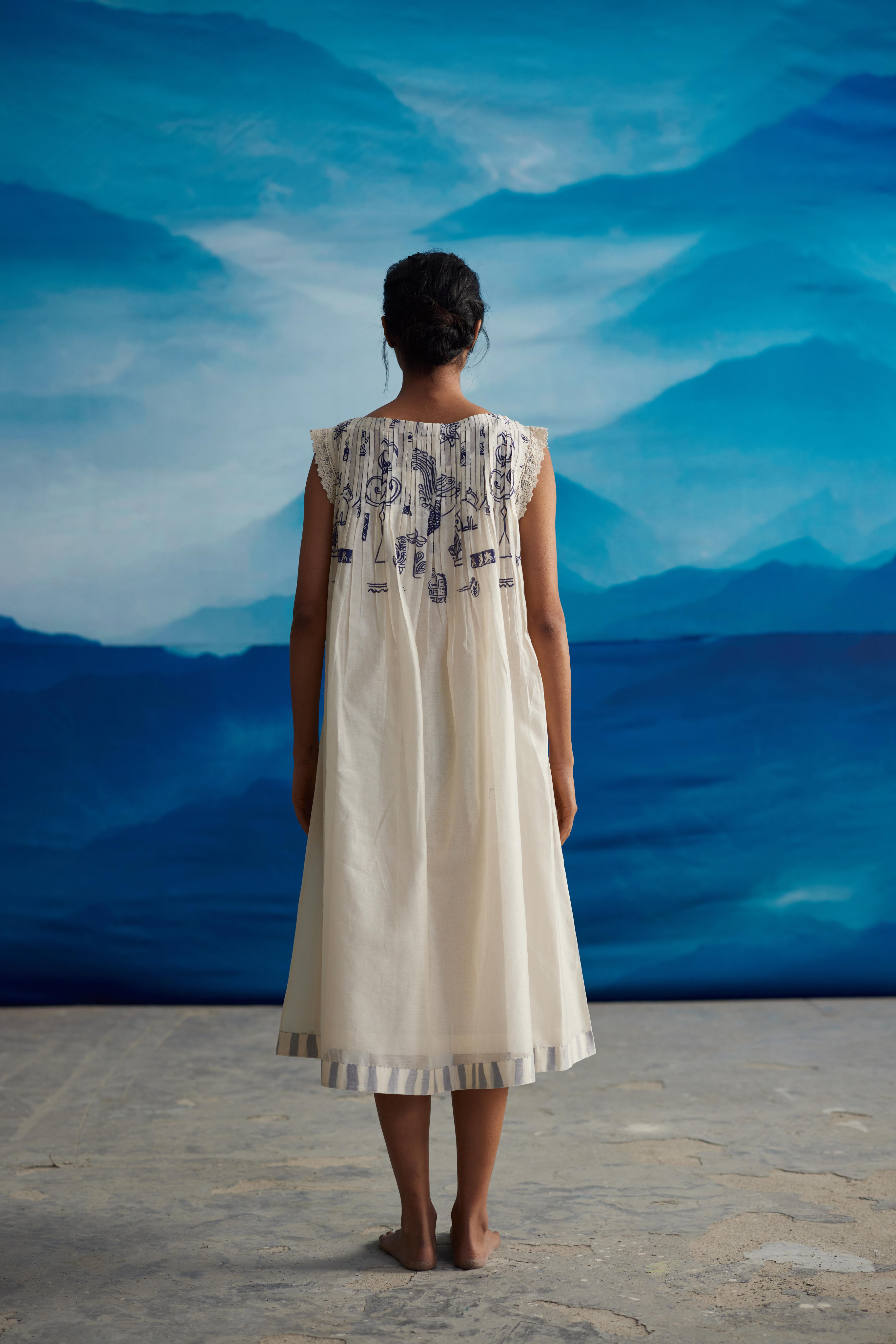 White Chanderi Pleated Midi Dress With Bow Tie-Up at Kamakhyaa by Ahmev. This item is Casual Wear, Chanderi, Indigo Eden by Ahmev, Korean Chic, Lace, Midi Dresses, Natural, Prints, Regular Fit, White, Womenswear