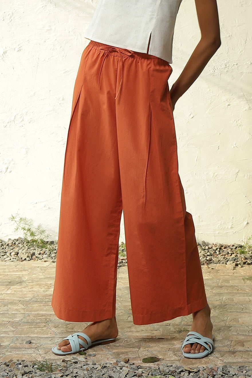 White Cotton Front Slit Top With Orange Palazzo Co-Ord Set at Kamakhyaa by Canoopi. This item is Canoopi, Casual Wear, Complete Sets, Khadi, Natural, Orange, Poplin, Regular Fit, Solids, Vacation Co-ords, White, Womenswear