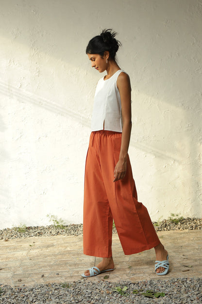 White Cotton Front Slit Top With Orange Palazzo Co-Ord Set at Kamakhyaa by Canoopi. This item is Canoopi, Casual Wear, Complete Sets, Khadi, Natural, Orange, Poplin, Regular Fit, Solids, Vacation Co-ords, White, Womenswear