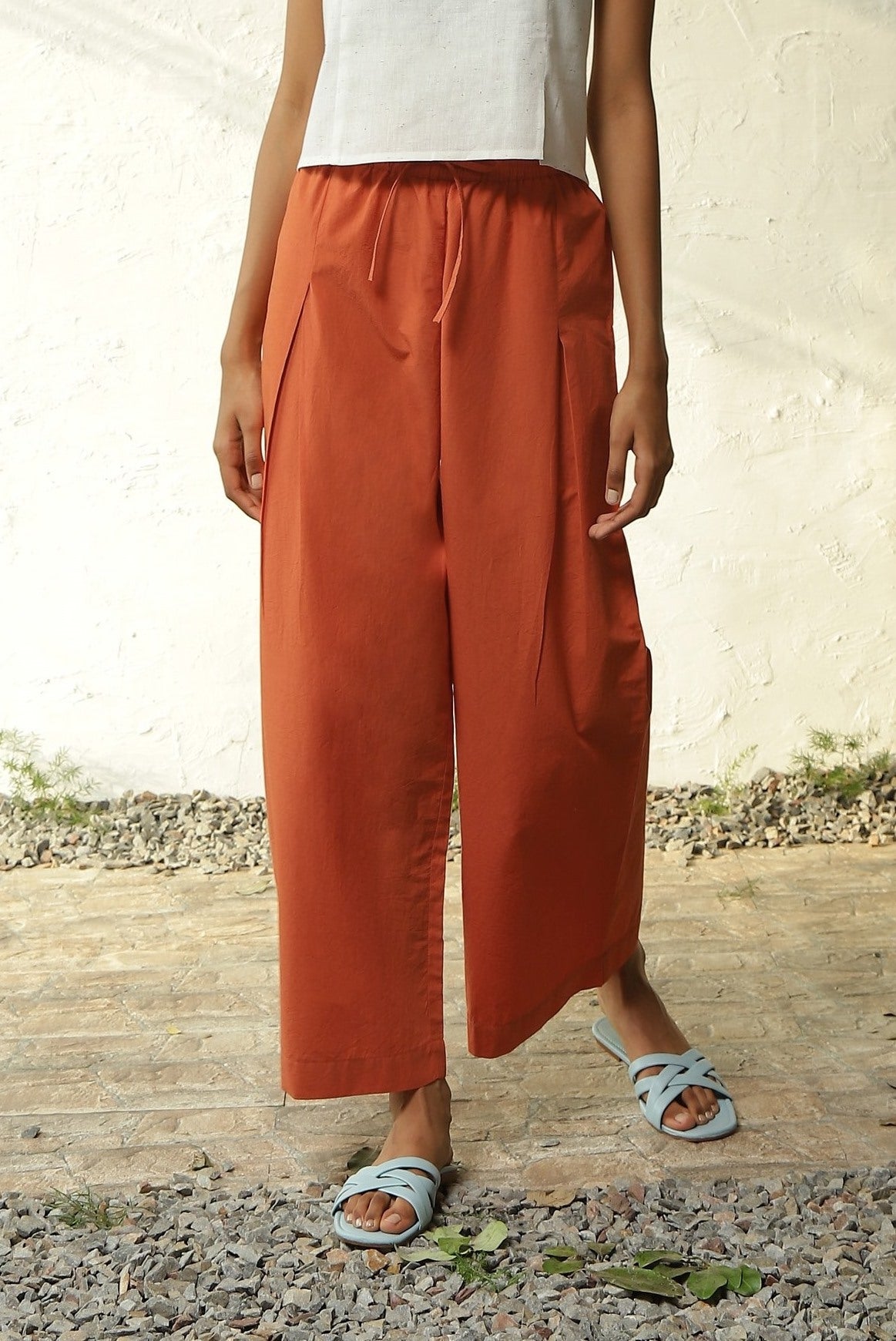 White Cotton Front Slit Top With Orange Palazzo Co-Ord Set at Kamakhyaa by Canoopi. This item is Canoopi, Casual Wear, Complete Sets, Khadi, Natural, Orange, Poplin, Regular Fit, Solids, Vacation Co-ords, White, Womenswear
