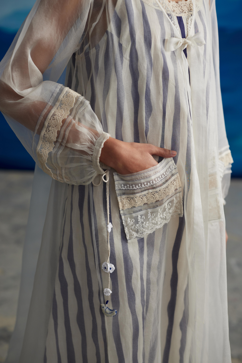 White Striped Tie-Up Midi Dress at Kamakhyaa by Ahmev. This item is Casual Wear, Indigo Eden by Ahmev, Korean Chic, Lace, Midi Dresses, Natural, Organza, Regular Fit, Stripes, White, Womenswear