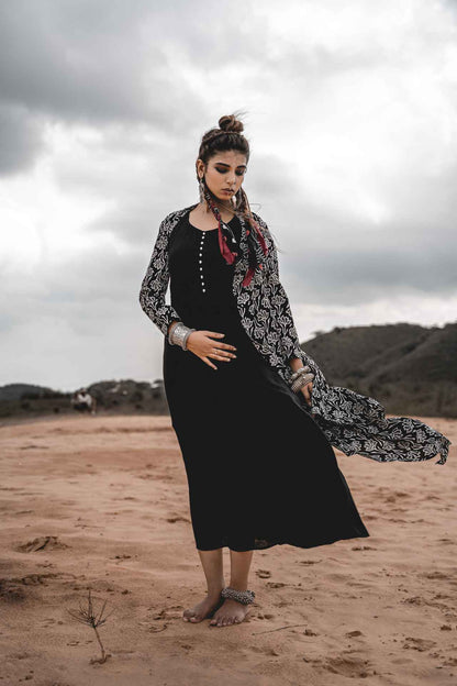Black Rayon Dress With Cotton Block Printed Asymmetric Cape - Set Of 2 at Kamakhyaa by Keva. This item is Black, Block Prints, Cape, Co-ord Sets, Cotton, Dress Sets, For Mother, For Mother W, Jackets, Midi Dresses, Natural, Relaxed Fit, Resort Wear, Wild Child, Womenswear