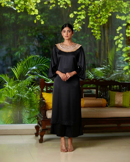 Black Satin Silk Kurta Pant Set at Kamakhyaa by Mayura Kumar. This item is Black, Casual Wear, Festive Wear, Kurta Pant Sets, Mayura Kumar, Regular Fit, Satin, Silk, Solids, Timeless Elegance, Womenswear