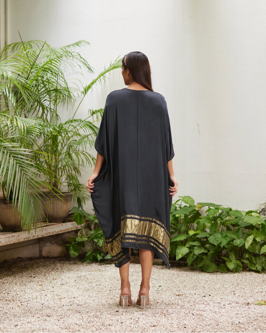 Black Silk Kaftan With Golden Border at Kamakhyaa by Mayura Kumar. This item is Ajrakh Heritage, Black, Casual Wear, Dresses, Festive Wear, Kaftans, Mayura Kumar, Modal Silk, Relaxed Fit, Solids, Womenswear