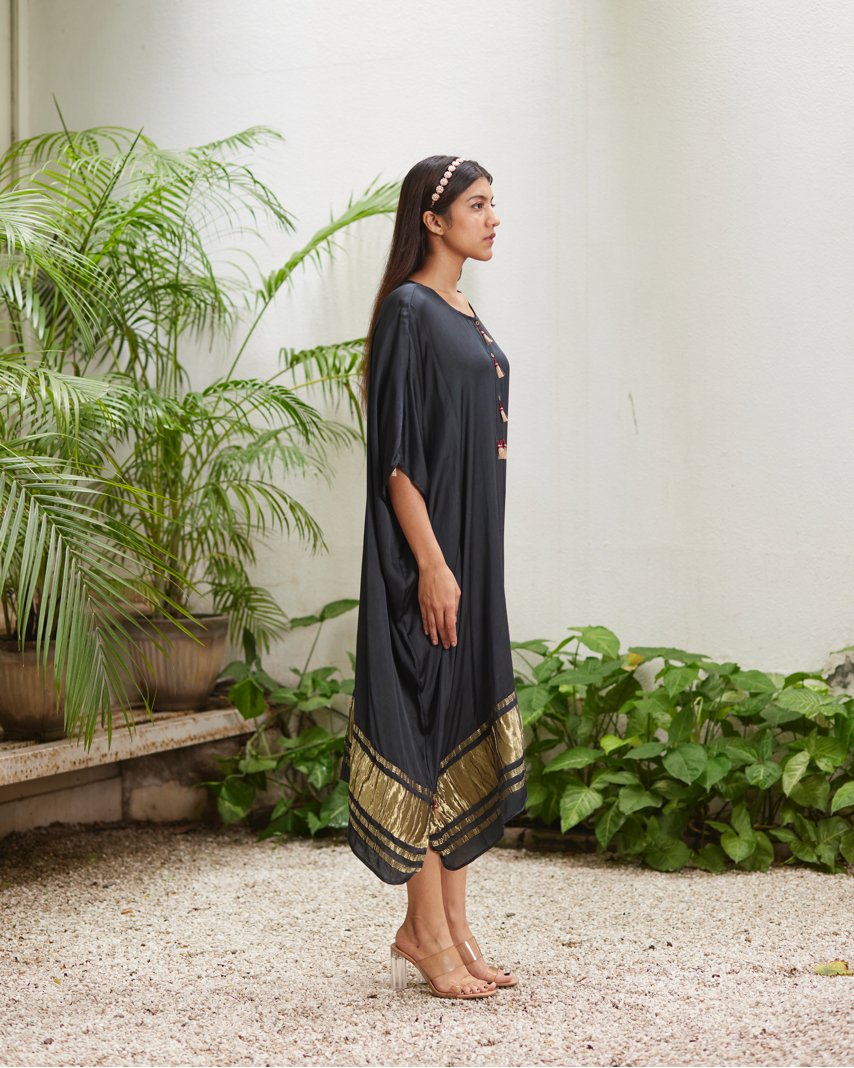Black Silk Kaftan With Golden Border at Kamakhyaa by Mayura Kumar. This item is Ajrakh Heritage, Black, Casual Wear, Dresses, Festive Wear, Kaftans, Mayura Kumar, Modal Silk, Relaxed Fit, Solids, Womenswear