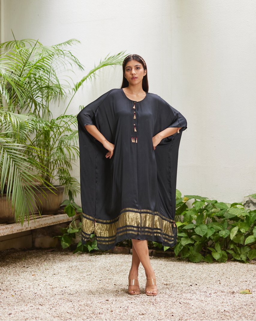 Black Silk Kaftan With Golden Border at Kamakhyaa by Mayura Kumar. This item is Ajrakh Heritage, Black, Casual Wear, Dresses, Festive Wear, Kaftans, Mayura Kumar, Modal Silk, Relaxed Fit, Solids, Womenswear