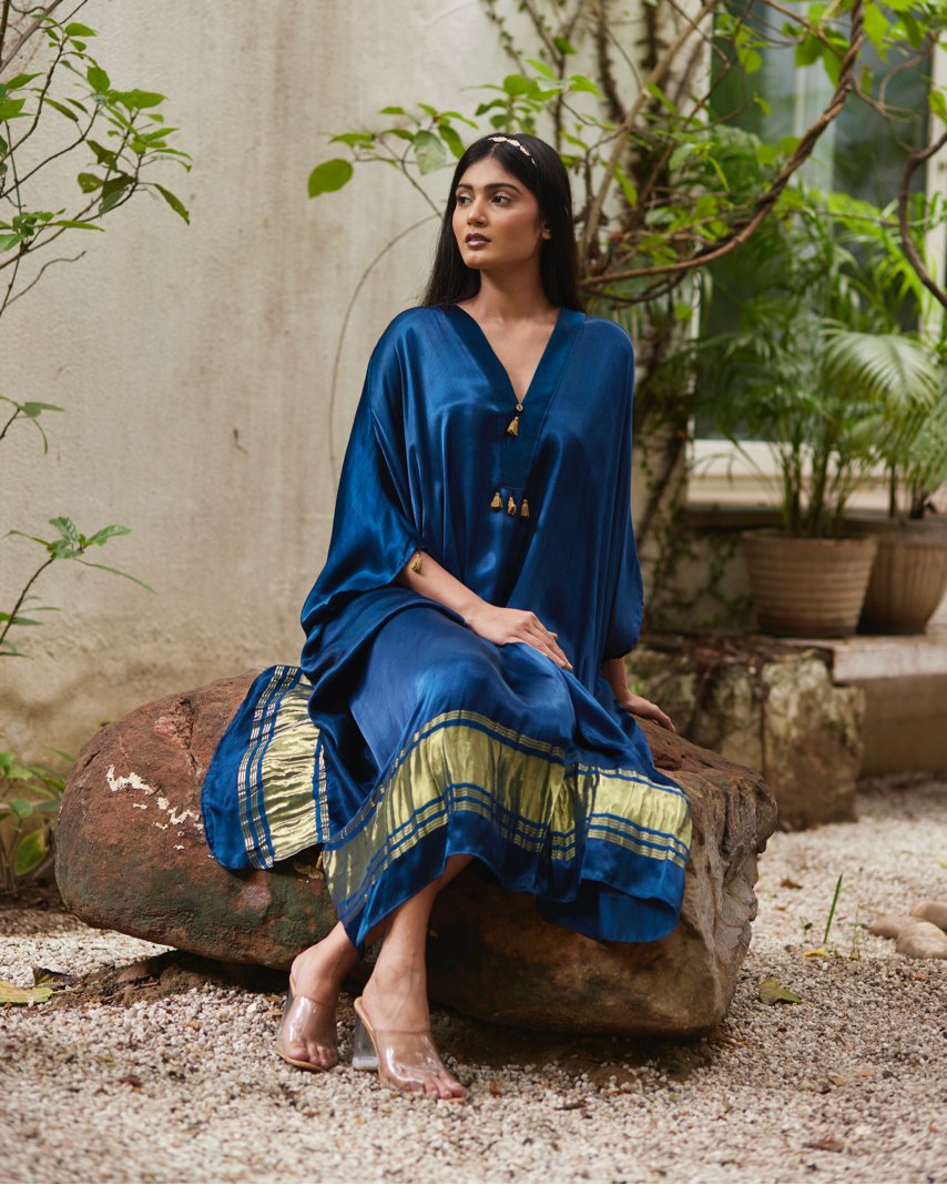 Blue Silk Kaftan With Golden Border at Kamakhyaa by Mayura Kumar. This item is Ajrakh Heritage, Blue, Casual Wear, Dresses, Festive Wear, Kaftans, Mayura Kumar, Modal Silk, Relaxed Fit, Solids, Womenswear