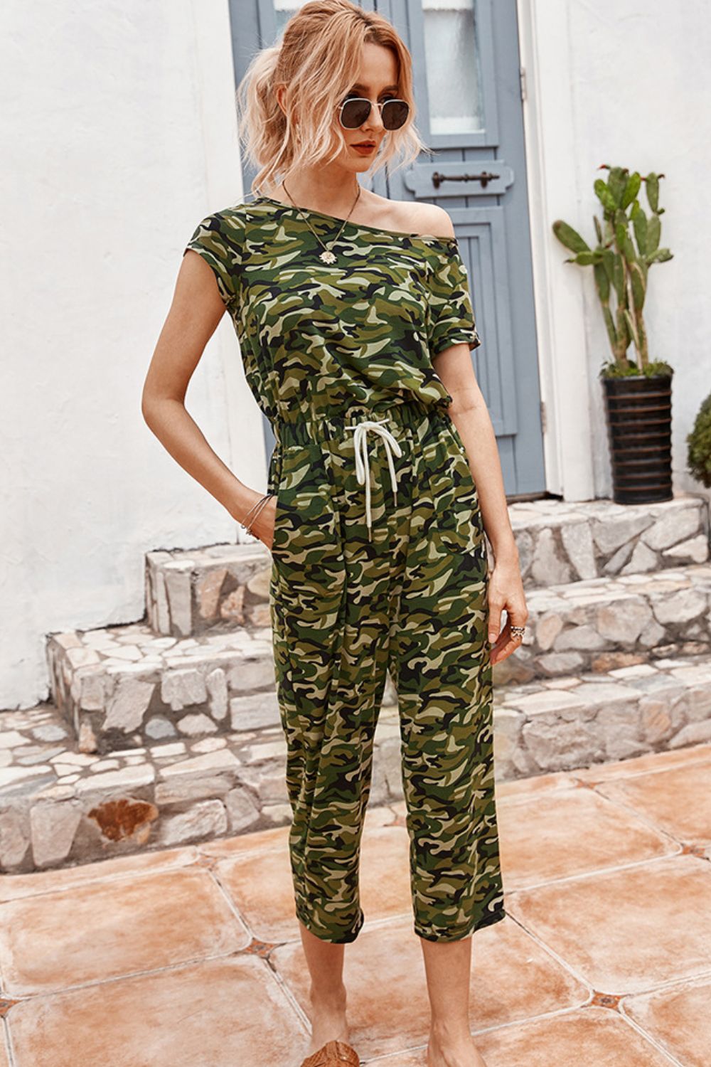 Camouflage Drawstring Crop Leg Jumpsuit at Kamakhyaa by Trendsi. This item is 100% cotton, Green, Jumpsuits, Natural, Prints, Regular Fit, Trendsi, Womenswear