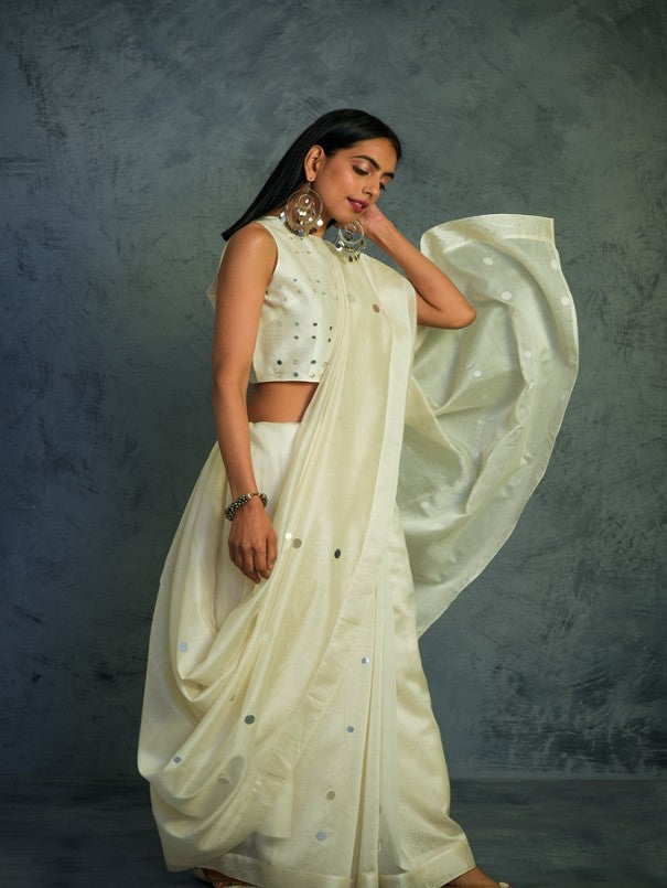 Chanderi Off-white Saree With Blouse at Kamakhyaa by Charkhee. This item is Chanderi, Cotton, Embellished, Ethnic Wear, Indian Wear, Mirror Work, Natural, Relaxed Fit, Saree Sets, Tyohaar, White, Womenswear