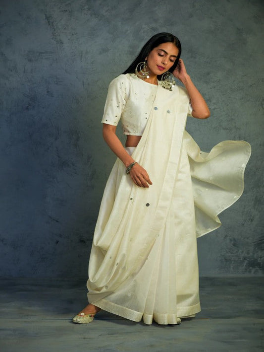 Chanderi Off-white Saree With Off-white Blouse at Kamakhyaa by Charkhee. This item is Chanderi, Cotton, Embellished, Ethnic Wear, Indian Wear, Mirror Work, Natural, Relaxed Fit, Saree Sets, Tyohaar, White, Womenswear