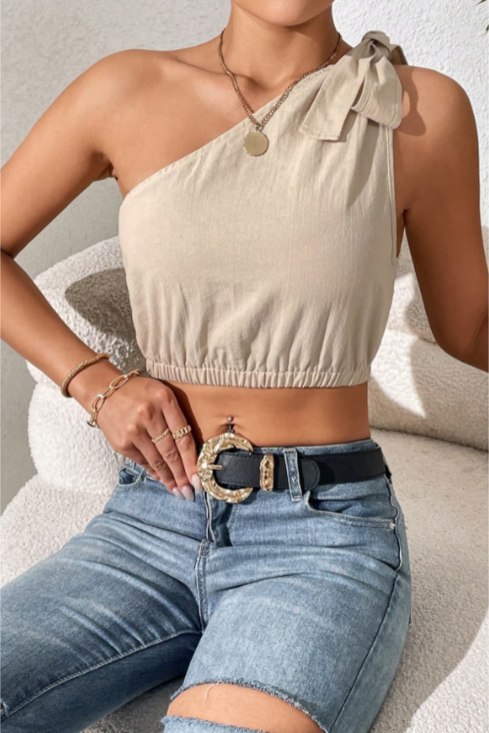 Cropped One-Shoulder Striped Tie Shoulder Tank at Kamakhyaa by Trendsi. This item is 100% cotton, Beige, Crop Tops, Natural, One Shoulder Tops, Regular Fit, Shipping Delay 09/29/2023 - 10/04/2023, Solids, Trendsi, Womenswear