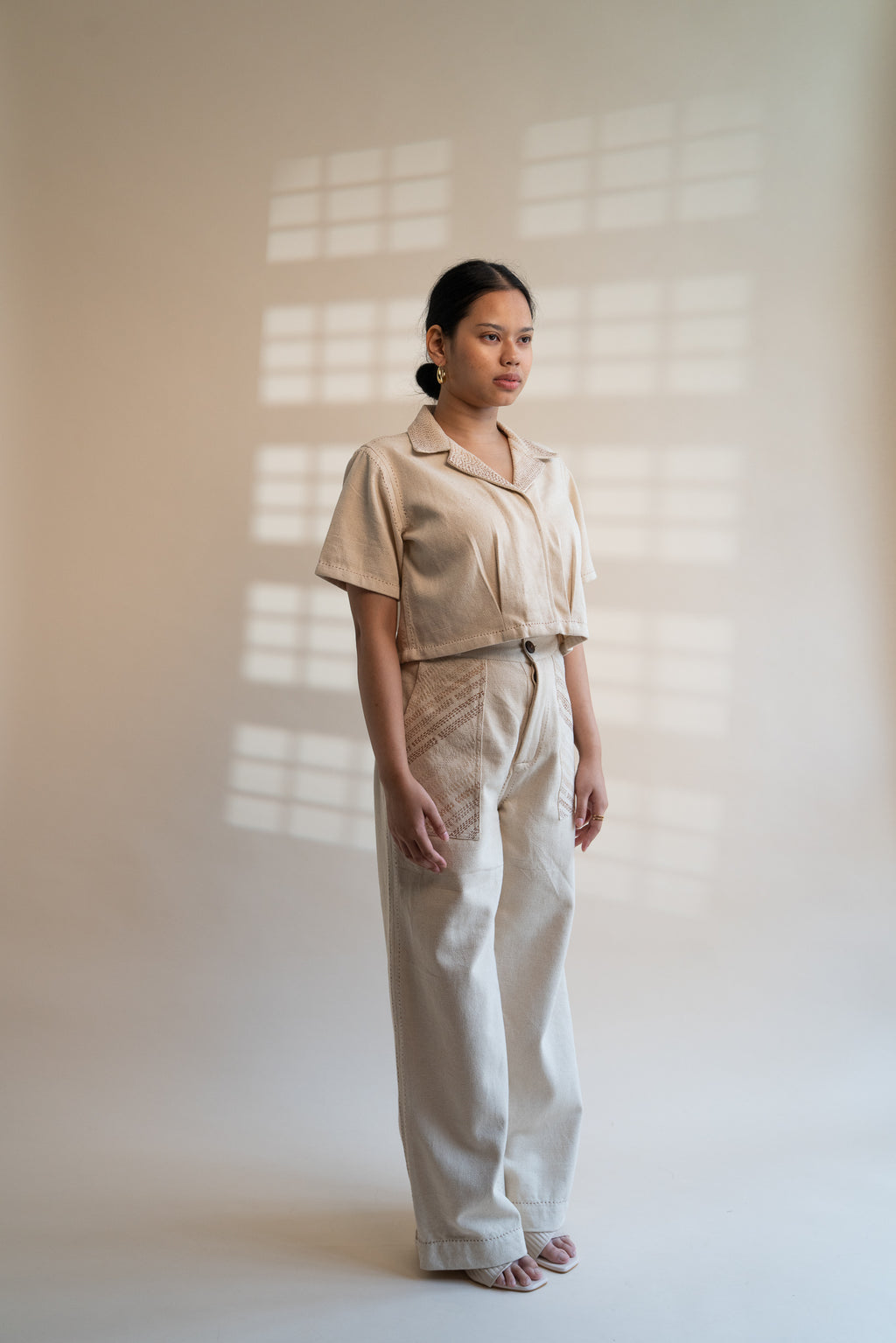 Dawning Denim Crop Jacket & Patch Pocket Pants Set at Kamakhyaa by Lafaani. This item is Beige, Casual Wear, Co-ord Sets, Denim, Embroidered, Hand Woven Cotton, Kora, Natural, Office, Office Wear Co-ords, Regular Fit, Womenswear