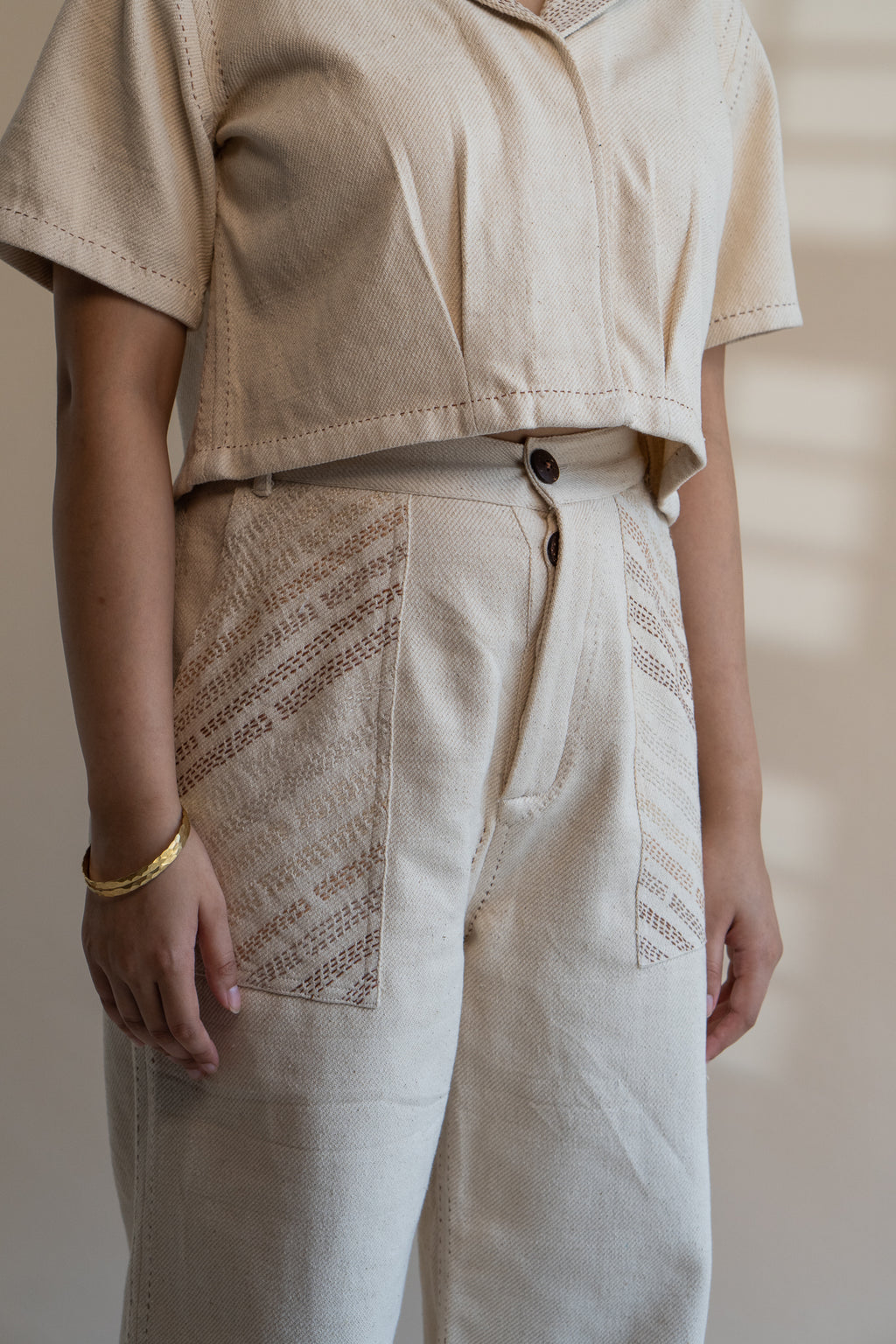 Dawning Denim Crop Jacket & Patch Pocket Pants Set at Kamakhyaa by Lafaani. This item is Beige, Casual Wear, Co-ord Sets, Denim, Embroidered, Hand Woven Cotton, Kora, Natural, Office, Office Wear Co-ords, Regular Fit, Womenswear