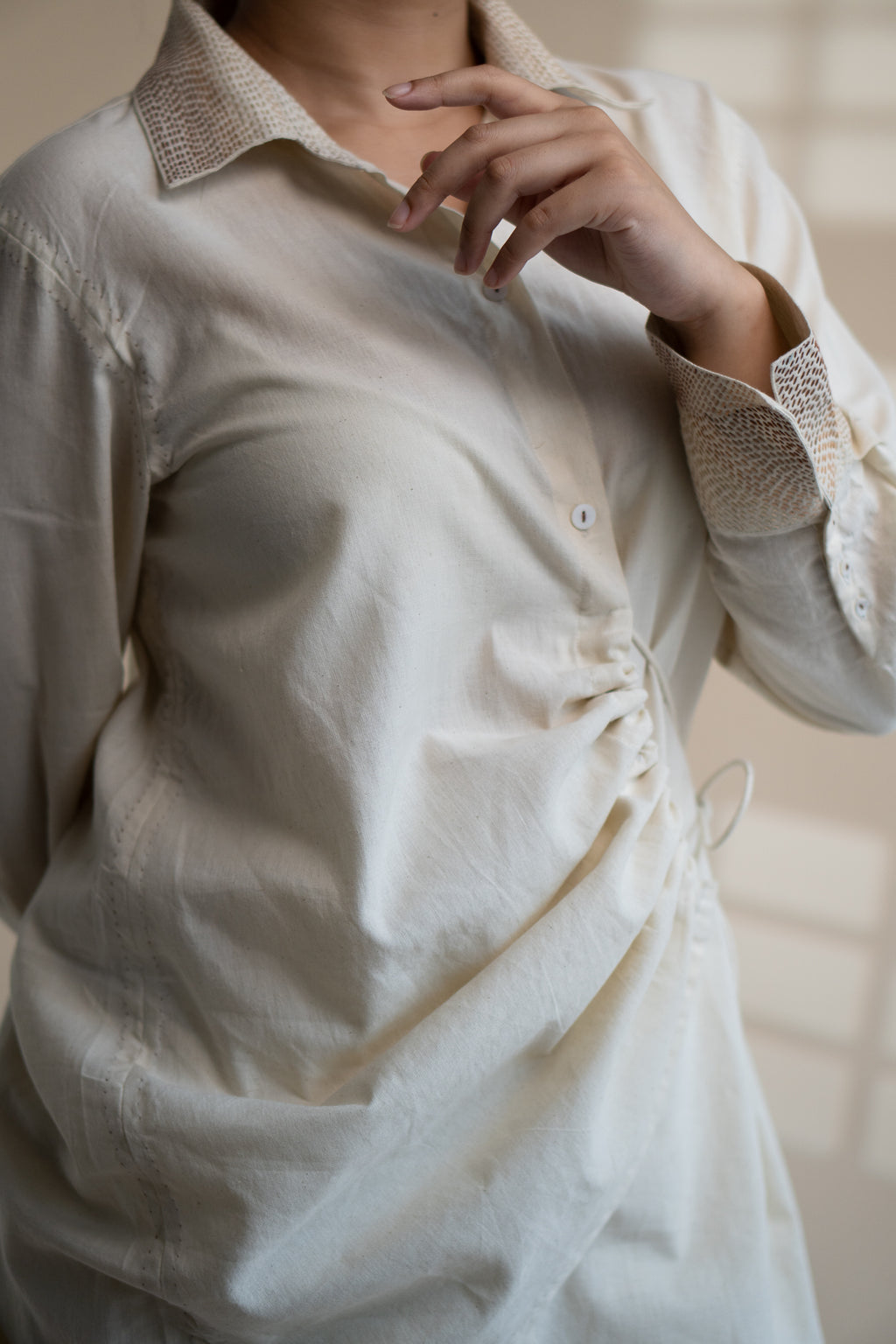 Dawning Draped Shirt at Kamakhyaa by Lafaani. This item is Beige, Casual Wear, Denim, Embroidered, Hand Woven Cotton, Kora, Natural, Relaxed Fit, Tops, Womenswear, Wrap Tops