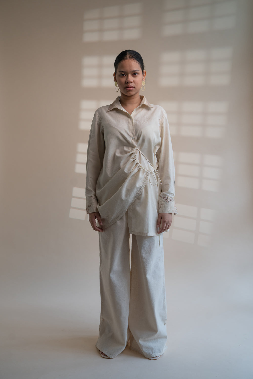 Dawning Draped Shirt at Kamakhyaa by Lafaani. This item is Beige, Casual Wear, Denim, Embroidered, Hand Woven Cotton, Kora, Natural, Relaxed Fit, Tops, Womenswear, Wrap Tops