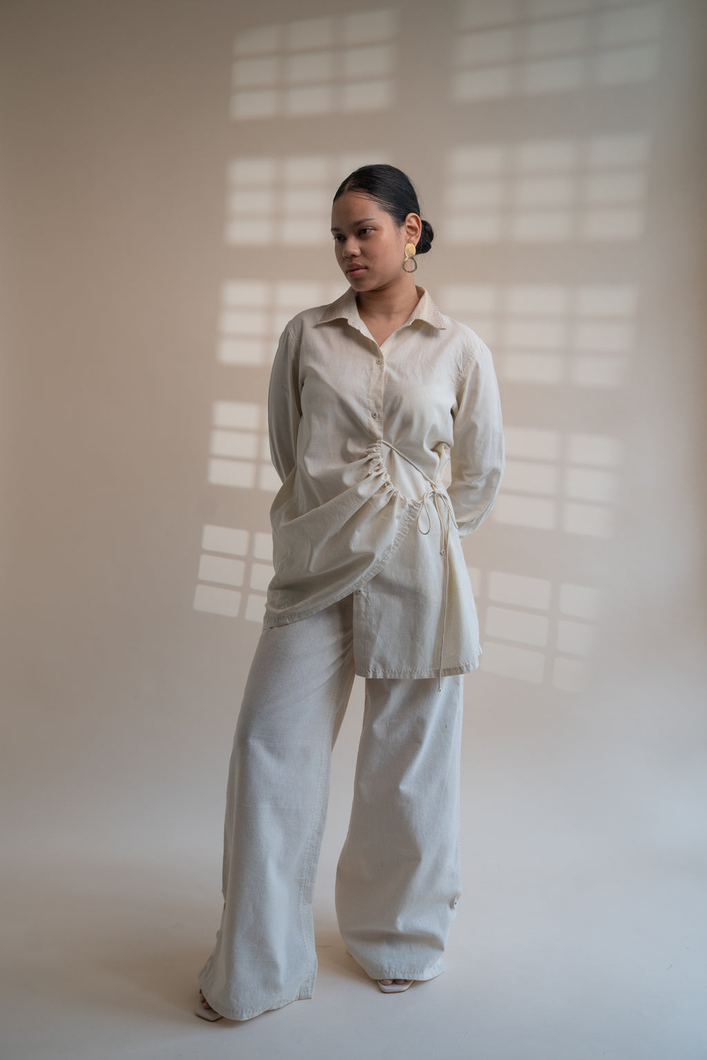 Dawning Draped Shirt at Kamakhyaa by Lafaani. This item is Beige, Casual Wear, Denim, Embroidered, Hand Woven Cotton, Kora, Natural, Relaxed Fit, Tops, Womenswear, Wrap Tops