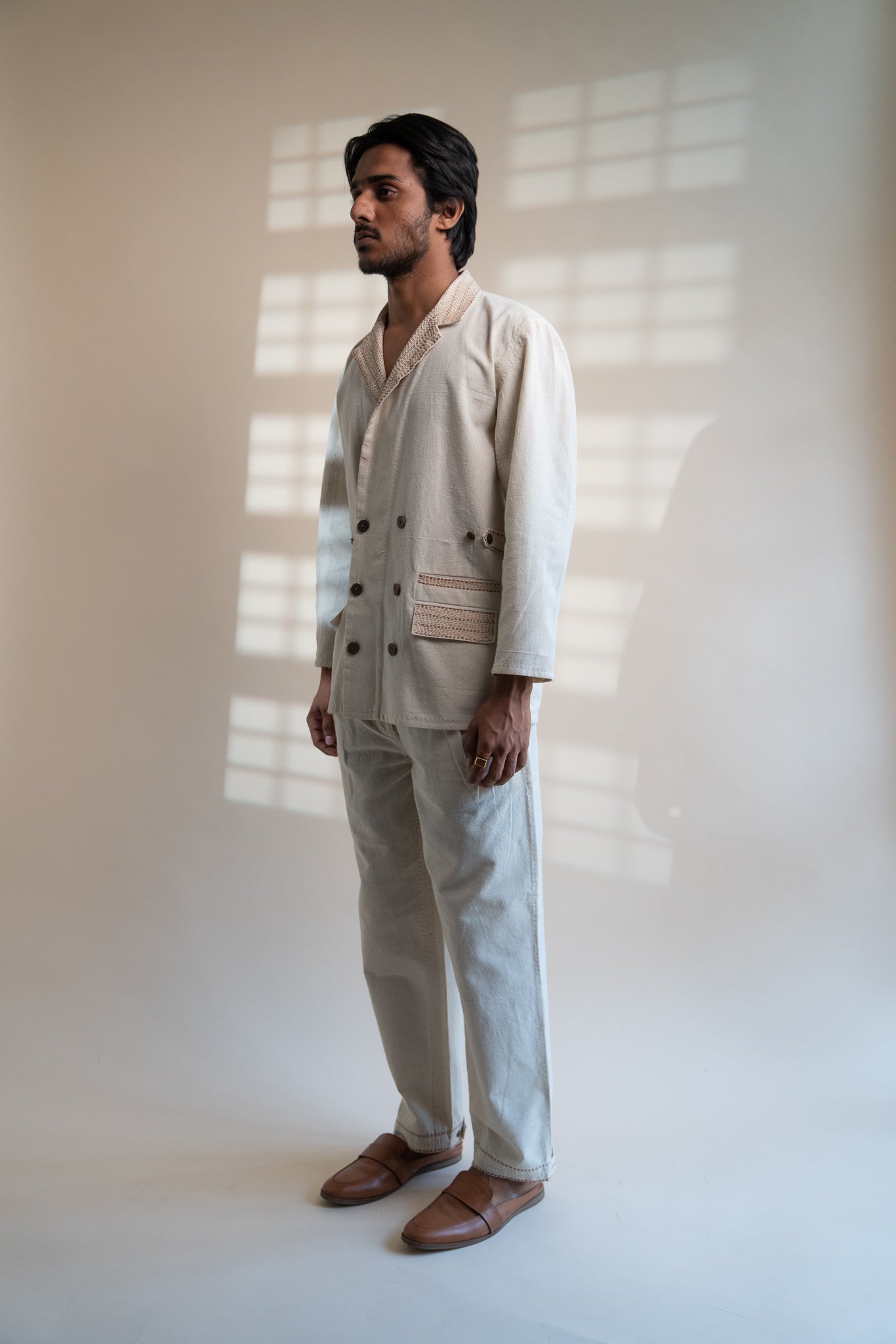 Dawning Unisex Double Breasted Jacket & Pleated Pants Set at Kamakhyaa by Lafaani. This item is Beige, Bottoms, Casual Wear, Co-ord Sets, Denim, Embroidered, For Him, Hand Woven Cotton, Kora, Mens Co-ords, Menswear, Natural, Regular Fit, Unisex