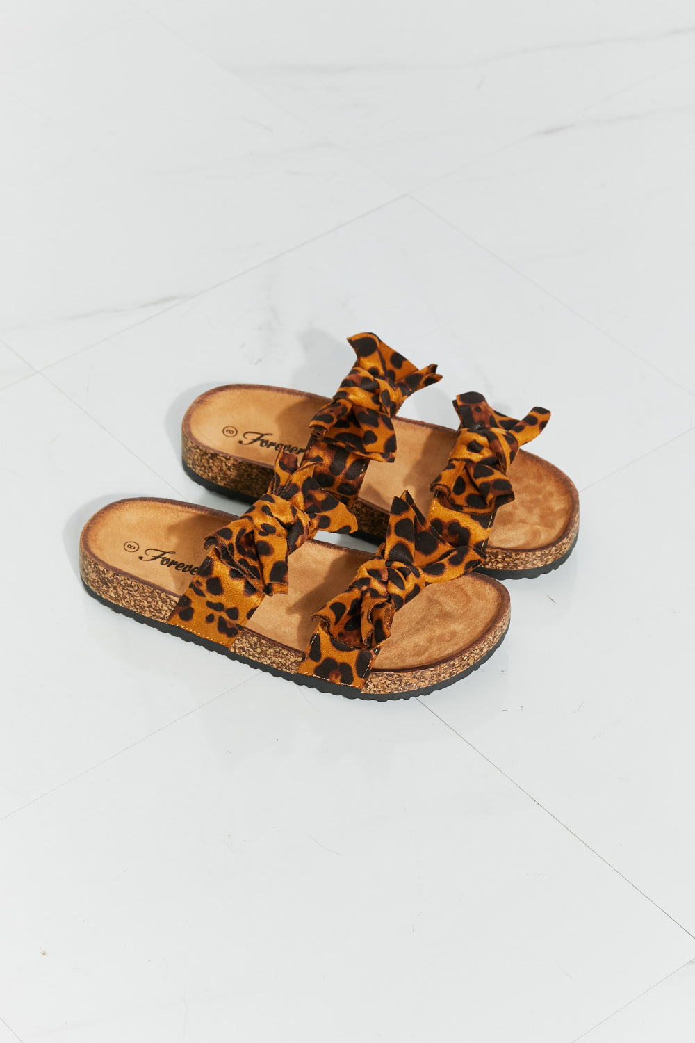 Forever Link Fiercely Feminine Leopard Bow Slide Sandals at Kamakhyaa by Forever Link. This item is Black Friday, Faux Leather, Flats, Forever Link, Natural, Regular Fit, Ship from USA, Solids, TPR