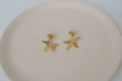 Gold Brass Tinted Star Studs at Kamakhyaa by The Loom Art. This item is Brass, Cosmic Dream TLA, Fashion Jewellery, Free Size, Gold, Gold Plated, jewelry, Less than $50, Natural, Office Wear Jewellery, Stud Earrings