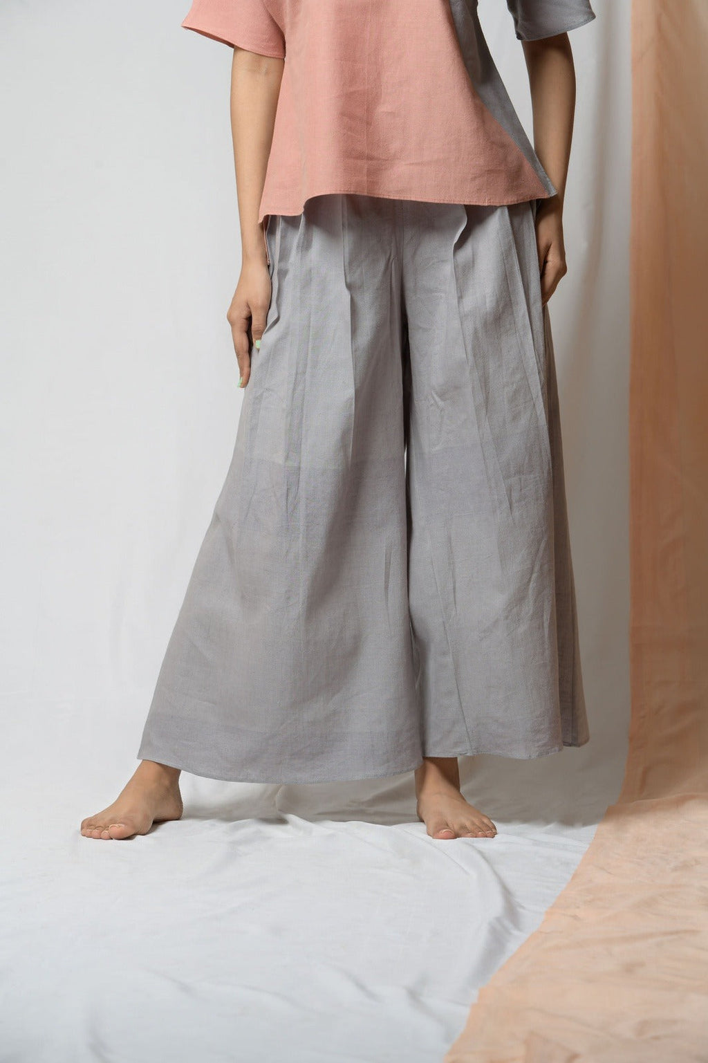 Grey Cotton Khadi Pants at Kamakhyaa by Niraa. This item is Casual Wear, Cotton khadi, Grey, Natural with azo dyes, Palazzo Pants, Relaxed Fit, Solids, Tales of rippling brooks, Womenswear