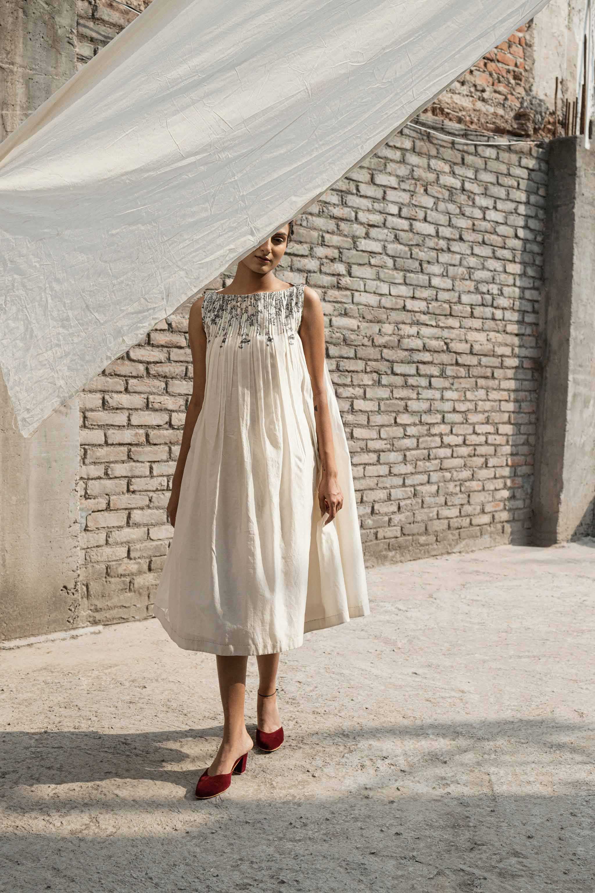 Ivory Pleated Neck Dress at Kamakhyaa by Ahmev. This item is Casual Wear, Chanderi, Ink And Ivory, Midi Dresses, Natural, Prints, Regular Fit, Sleeveless Dresses, White, Womenswear