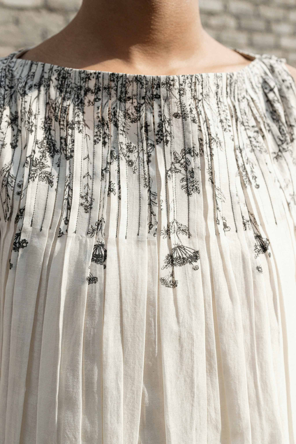 Ivory Pleated Neck Dress at Kamakhyaa by Ahmev. This item is Casual Wear, Chanderi, Ink And Ivory, Midi Dresses, Natural, Prints, Regular Fit, Sleeveless Dresses, White, Womenswear