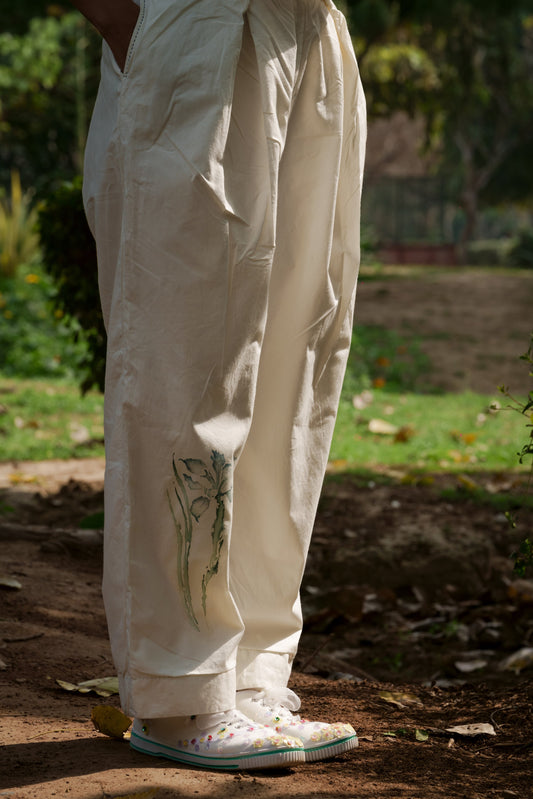 Ivory pleated pants at Kamakhyaa by Ahmev. This item is Batik, Casual Wear, Cotton, Fitted At Waist, Handpainted, July Sale, July Sale 2023, Natural, Pants, Solids, White, Womenswear