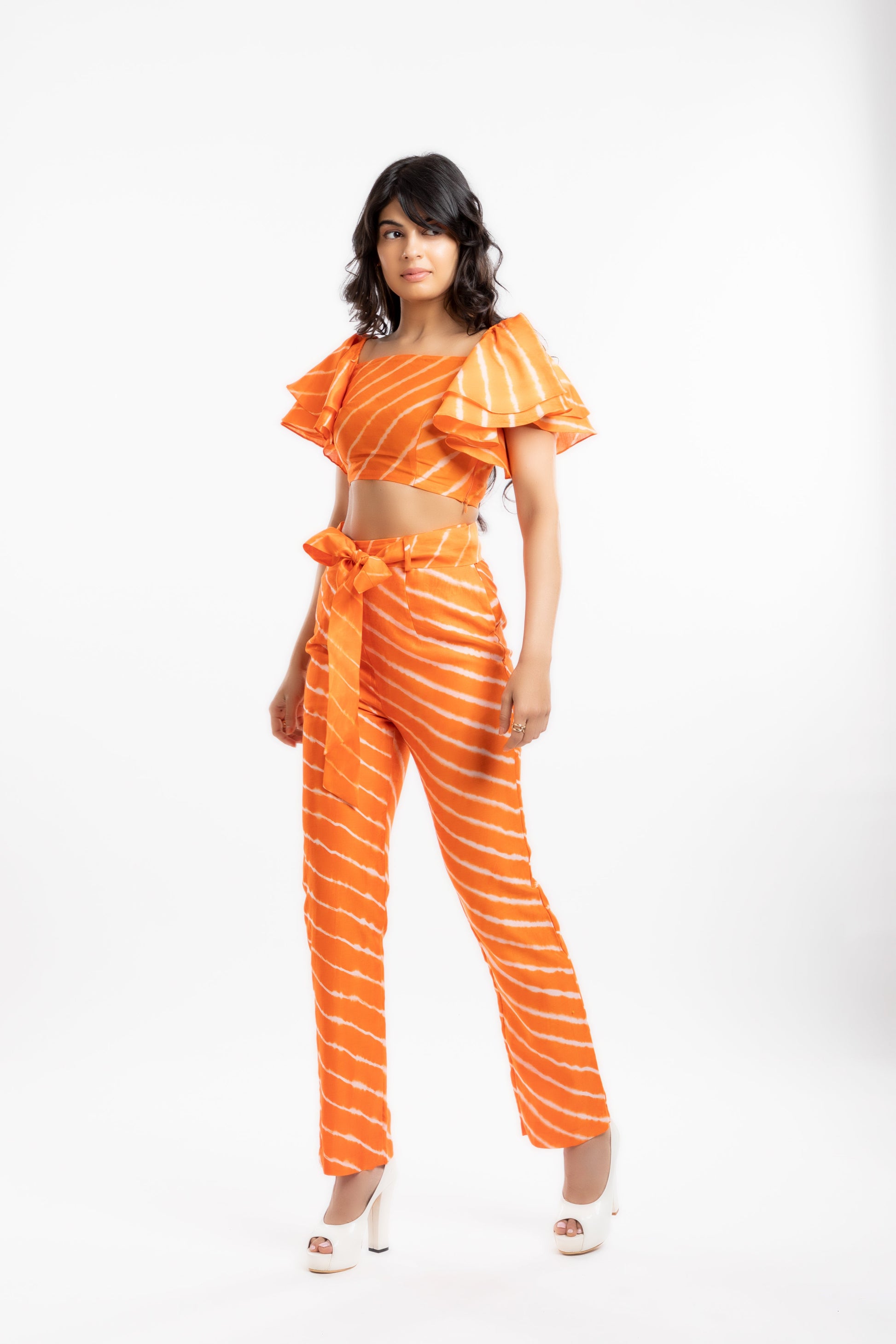 Orange Crop Top with Ruffles at Kamakhyaa by House Of Ara. This item is Casual Wear, Chanderi, Cotton, Crop Tops, Fitted at Bust, Leheriya, Leheriya Collection, Natural, Off-shoulder Tops, Orange, Silk, Stripes, Womenswear