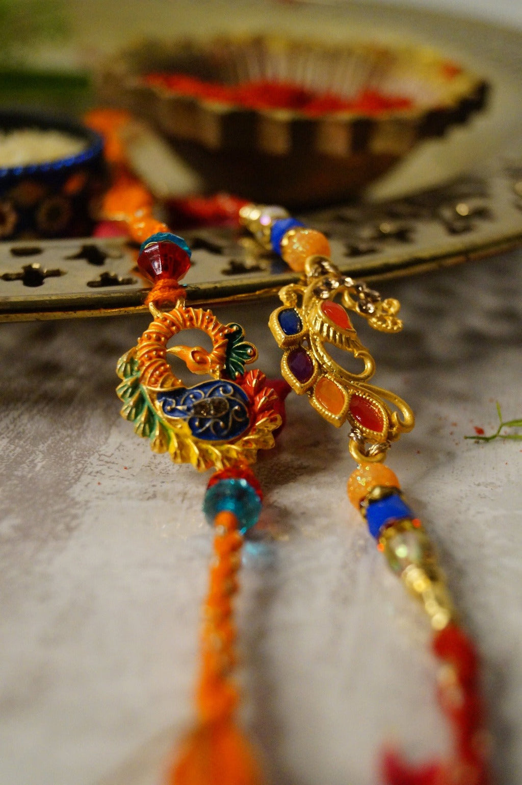 Peaccock Colorful Stone and Gold Brass Thread Rakhi at Kamakhyaa by Kamakhyaa. This item is Multicolor, Natural, Rakhi, Under 1500, Under 1750, Upcycled