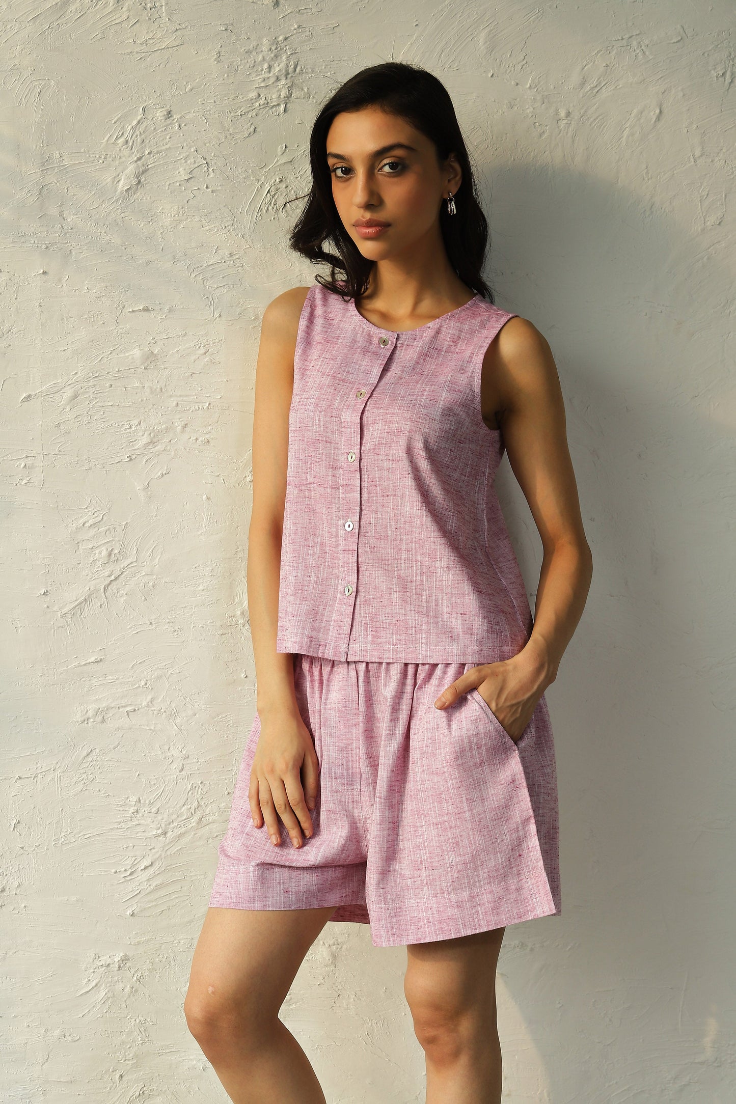 Pink Sleeveless Buttoned Top With Shorts Co-Ord Set at Kamakhyaa by Canoopi. This item is Canoopi, Casual Wear, Complete Sets, Khadi, Natural, Pink, Regular Fit, Solids, Vacation Co-ords, Womenswear