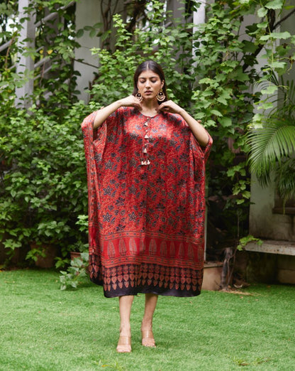 Red Floral Printed Silk Kaftan at Kamakhyaa by Mayura Kumar. This item is Ajrakh Heritage, Casual Wear, Dresses, Festive Wear, Kaftans, Mayura Kumar, Modal Silk, Prints, Red, Relaxed Fit, Womenswear
