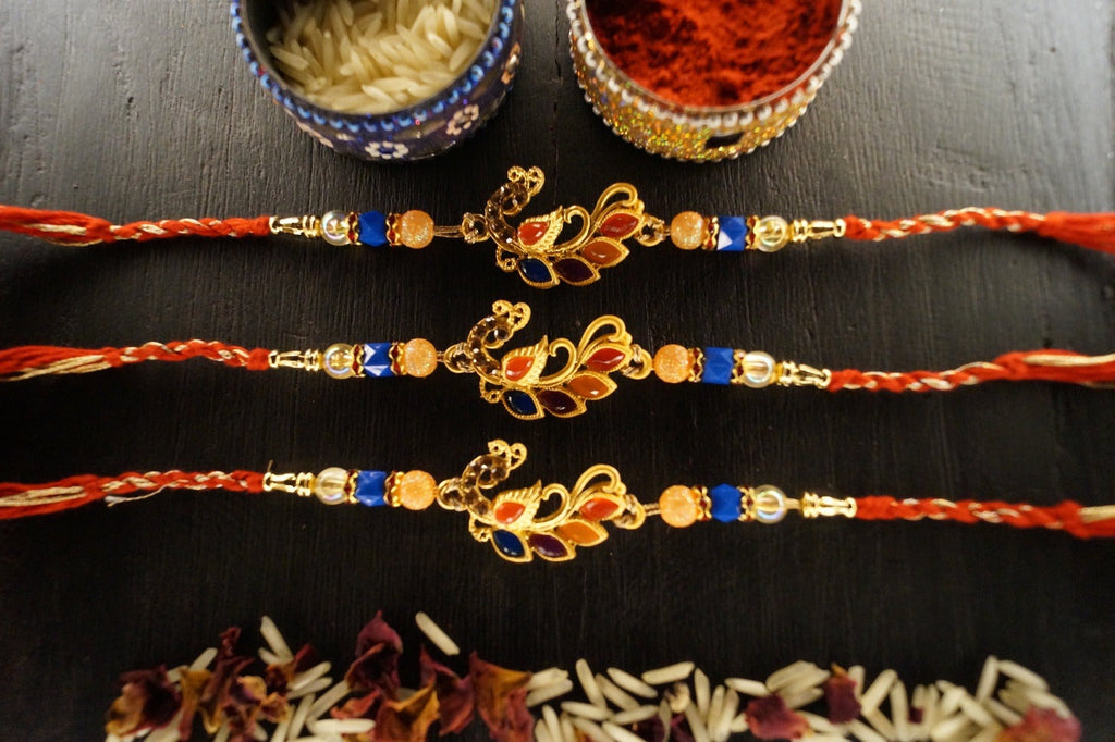 Set of 3-Peacock Colorful Stone Thread Rakhi at Kamakhyaa by Kamakhyaa. This item is jewelry, Multicolor, Natural, Rakhi, Under 1500, Under 1750, Upcycled