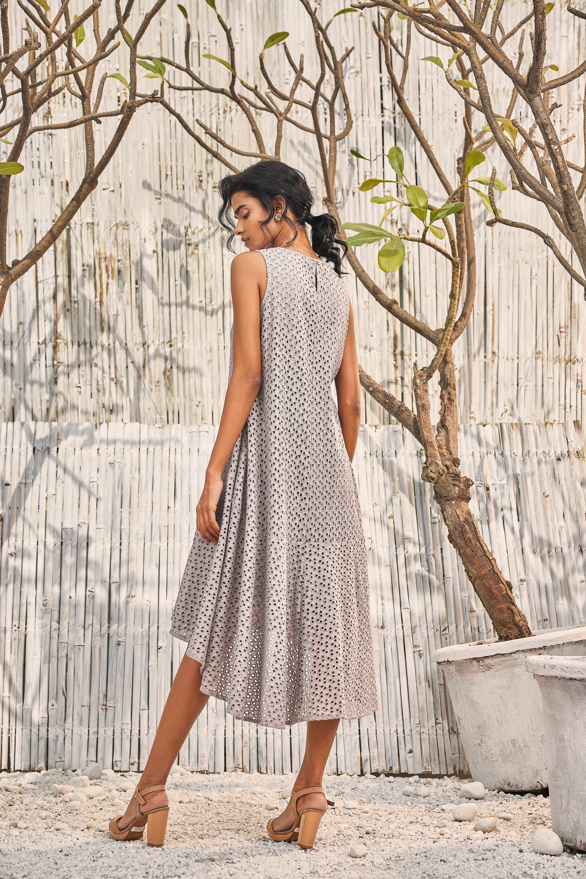 Steel Grey High-Low Cutwork Flared Dress at Kamakhyaa by Charkhee. This item is Best Selling, Cotton, Festive Wear, Grey, Midi Dresses, Natural, Regular Fit, Schiffli, Shores 23, Sleeveless Dresses, Textured, Womenswear