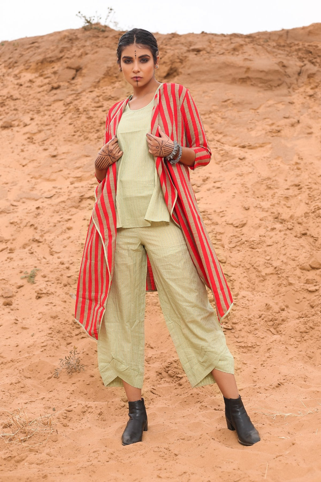 Top With Pants And Red Striped Cape - Set Of Three at Kamakhyaa by Keva. This item is Cape, Co-ord Sets, Cotton, Cotton Lurex, Desert Rose, Natural, Office Wear Co-ords, Red, Relaxed Fit, Resort Wear, Stripes, Travel, Travel Co-ords, Womenswear